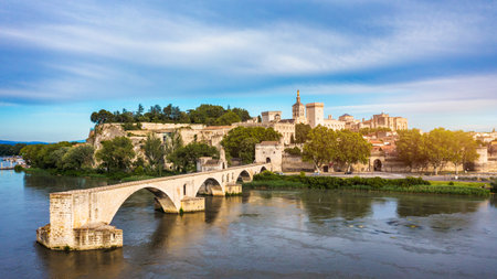 Beautiful view of Avignon with famous bridge Saint-Benezet, medieval architecture along the Rhone River in Avignon, France. The Pont Saint Benezet and the Papal palace in Avignon, South France.の写真素材