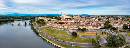 Beautiful view of Avignon with famous bridge Saint-Benezet, medieval architecture along the Rhone River in Avignon, France. The Pont Saint Benezet and the Papal palace in Avignon, South France.の写真素材
