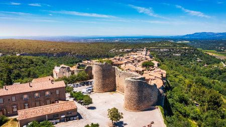 View of Venasque village with old church Notre Dame de Vie to landscape of Luberons, Provence, France. Beautiful Church and houses in the town of Venasque, Provence, France.の写真素材