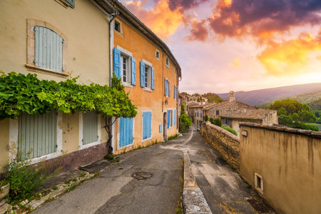 Charming street in quaint Menerbes village with colorful buildings and vibrant flowers. Village of Menerbes (Most Beautiful Village in France) in the Luberon mountains, France, Luberon, Vaucluse.の写真素材