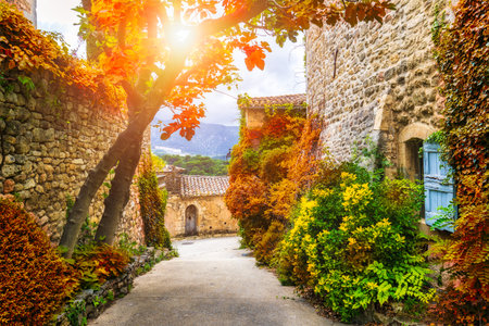 Charming street in quaint Menerbes village with colorful buildings and vibrant flowers. Village of Menerbes (Most Beautiful Village in France) in the Luberon mountains, France, Luberon, Vaucluse.の写真素材