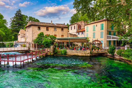 Fontaine de Vaucluse village with charming riverside in a picturesque town with colorful buildings during a peaceful afternoon. France, Provence, Vaucluse, Pays des Sorgues, Fontaine de Vaucluse.の写真素材