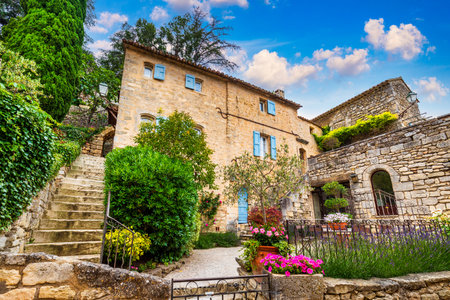 Charming street in quaint Menerbes village with colorful buildings and vibrant flowers. Village of Menerbes (Most Beautiful Village in France) in the Luberon mountains, France, Luberon, Vaucluse.の写真素材