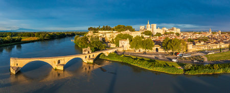 Beautiful view of Avignon with famous bridge Saint-Benezet, medieval architecture along the Rhone River in Avignon, France. The Pont Saint Benezet and the Papal palace in Avignon, South France.の写真素材