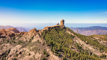 Roque Nublo and Pico de Teide in the background on Gran Canaria Island, Spain. Panoramic view of Roque Nublo sacred mountain, Roque Nublo Rural Park, Gran Canary, Canary Islands, Spain.の写真素材