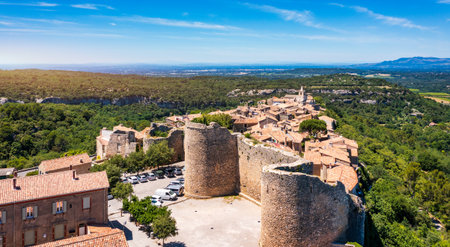 View of Venasque village with old church Notre Dame de Vie to landscape of Luberons, Provence, France. Beautiful Church and houses in the town of Venasque, Provence, France.の写真素材