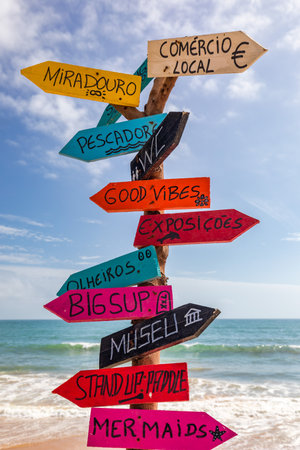 A sign post with many different colored signs on it