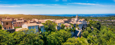 View of Venasque village with old church Notre Dame de Vie to landscape of Luberons, Provence, France. Beautiful Church and houses in the town of Venasque, Provence, France.の写真素材