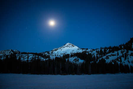 Mountain peak at night with moonの写真素材