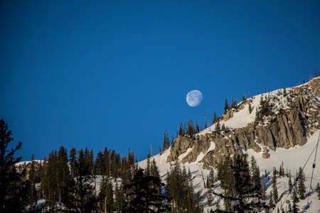 moon rise over mountain peakの写真素材