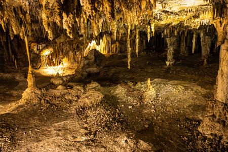 Inside a cave with calcium carbonate rock formation with stalactites and stalagmitesの写真素材