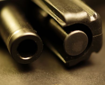 This is a 9mm gun laying on its side with the slide pulled back and the barrel disengaged. That is...
