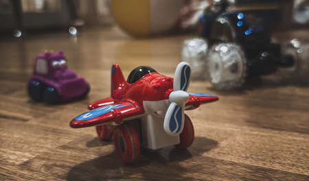 Toy red plane, other toys on backgroundの写真素材