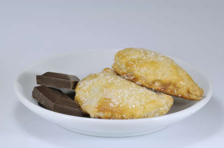 rafioli and two pieces of chocolate on coffee-cup plate with white background - DSC0907の写真素材