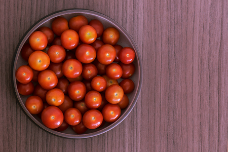 Bowl full of fresh red cherry tomatoesの写真素材