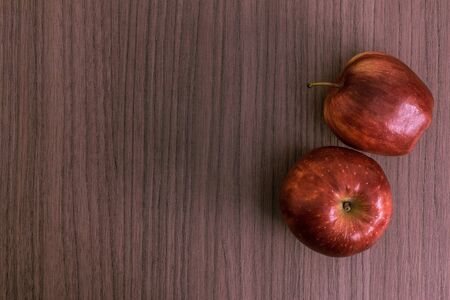Two nice red apples over wood backgroundの写真素材