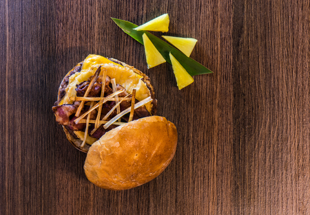 Top view of tasty pineapple-bacon hamburger and all its ingredientsの写真素材