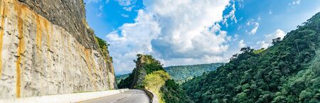 Mountain traversed by road in the way Villeta - Bogota, Cundinamarca framed by rock and forestの写真素材