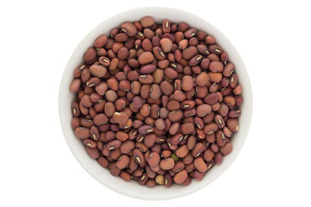 Dried red azuki beans in white bowl, isolated on white backgroundの写真素材