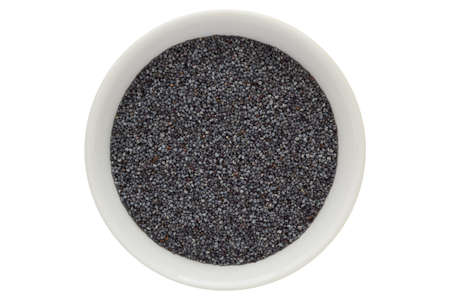 Poppy seeds in white bowl, isolated on white backgroundの写真素材