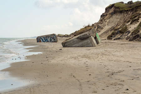 German World War II bunkers sinking into the sand, Skiveren beach, Denmarkの写真素材