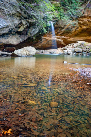 Cascading waterfall flows into the gorge near Old Man's Cave in Ohio's Hocking Hills State Park.の写真素材
