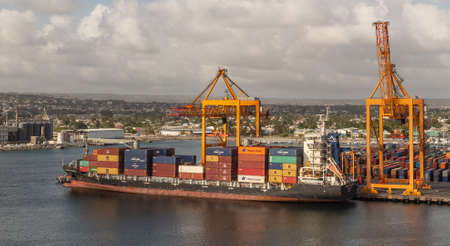 Bridgetown port, Barbados, West Indies - May 2, 2020: Bridgetown port with loading cranes and cargo...