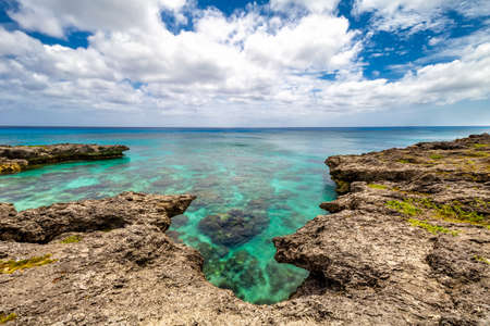 Background view of shallow turquoise waters with coral reefs underneath the surface and fringing reefs encircling it above the surface. Clear horizonの写真素材