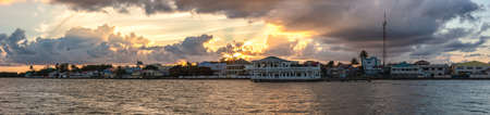 Beautiful panoramic shot of Belize city at sunset. Amazing orange sky and clouds in the background.の写真素材
