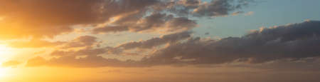 Amazing panoramic cloudscape at sunset in La Manche. Beautiful warm orange clouds.の写真素材