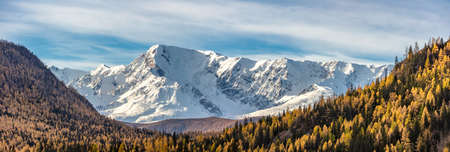 Scenic panoramic aerial view of snowy mountain peaks and slopes of North Chuyskiy ridge. Golden...