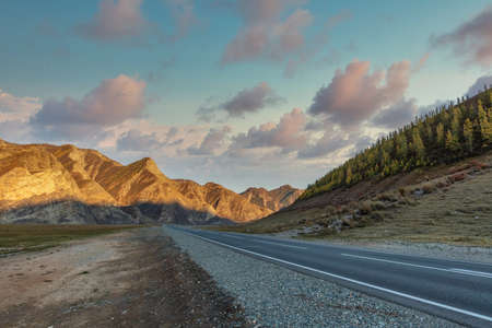 Scenic low angle view of mountain ridge. Highway in the foreground leading all the way up to the...