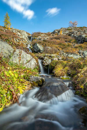 Beautiful low angle shot of waterfall in Altai mountains in Siberia, Russia. Karakolskie lakes....