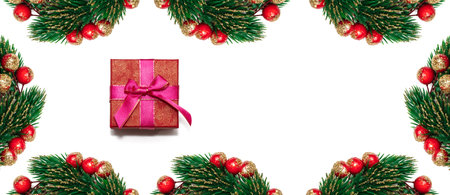 Decorative Christmas spruce branches with red, golden berries encircling white copy space and red...