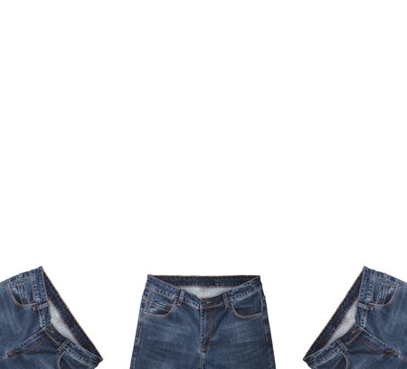 Front pockets, waist areas, zippers, and buttons of three pairs of dark blue jeans isolated on white background. Close up shot. Copy space above jeans. Portrait, vertical size. Clothing concept.の写真素材