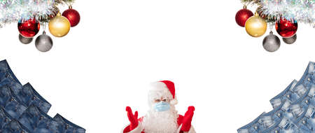 Santa Claus wearing mask, pointing at huge piles of blue jeans isolated on white background. Christmas twigs with balls above them. Banner size, copy space. Clothing, online store concepts.の写真素材