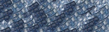 Background made of dark blue and light blue jeans with white faded spots. Banner size.の写真素材