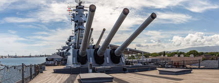 Pearl Harbor, Hawaii, USA - September 24, 2018: Panoramic shot of huge cannons and deck of USS Missouri docked in Pearl Harbor. Blue sky with white clouds as a background.のeditorial素材
