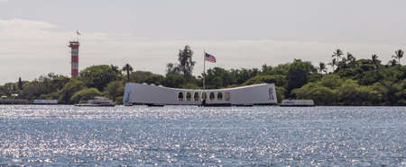 Pearl Harbor, Hawaii, USA - September 23, 2018: Distant shot of USS Arizona memorial with american flag waving above it.のeditorial素材