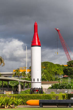 Pearl Harbor, Hawaii, USA - September 23, 2018: Red tipped US Navy Polaris ballistic missile on display next to the USS Arizona Memorial Visitor Center. Dark cloudy sky, green foliage as a backdrop.のeditorial素材