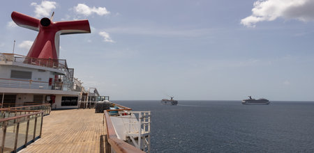 Saint Vincent and the Grenadines - May 8, 2020: Panoramic shot of open decks and red funnel on Carnival Freedom. Carnival Valor, Carnival Fascination, blue sky with white clouds in the background.のeditorial素材