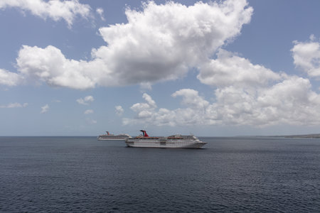 Saint Vincent and the Grenadines - May 8, 2020: Aerial shot of Carnival Fascination anchored by the island. Carnival Valor and blue sky with white clouds in the background.のeditorial素材
