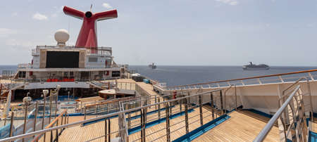 Saint Vincent and the Grenadines - May 8, 2020: Panoramic shot of open decks and red funnel on Carnival Freedom. Carnival Valor, Carnival Fascination, blue sky with white clouds in the background.のeditorial素材