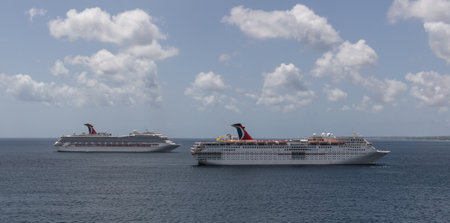 Saint Vincent and the Grenadines - May 8, 2020: Aerial shot of Carnival Fascination anchored by the island. Carnival Valor and blue sky with white clouds in the background.のeditorial素材