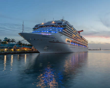 Nassau, Bahamas - June 22, 2019: Carnival Liberty cruise ship docked at Prince George Wharf at sunset. Blue and orange sky in the background. Low angle shot. Beginning of the blue hour.のeditorial素材