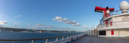 Weymouth Bay, England - July 5, 2020: Panoramic shot of open decks and red funnel on Carnival Valor. White cliffs, blue sky with white clouds in the background.のeditorial素材