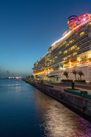 Nassau, Bahamas - July 13, 2019: Shot of Mariner of the Seas at Prince George Wharf at sunset. Blue hour. Gorgeous light reflections in the water in the foreground. Clear blue sky in the background.のeditorial素材