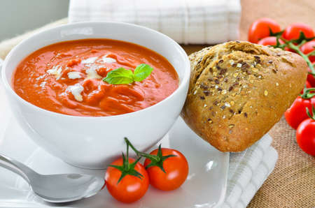 Tomato soup with crusty bread rollsの写真素材