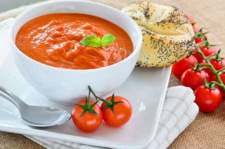 Tomato soup and crusty bread rollsの写真素材