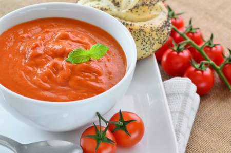 Tomato soup and crusty bread rollsの写真素材